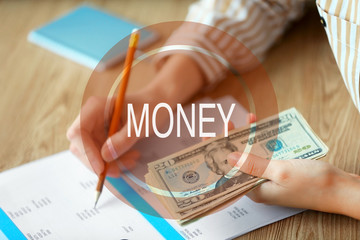 Poster - Money icon. Woman counting money at the table