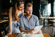 © NDABCREATIVITY - Beautiful couple looking at tablet