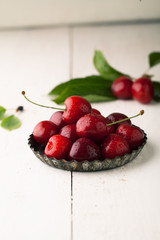 Canvas Print - Ripe cherry with leaf  on a white