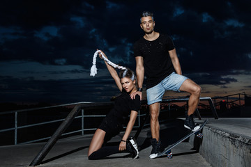 Stylish couple in the skate park