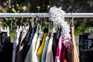 Wall Mural - second hand women's jackets on display at flea market