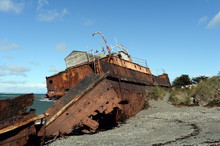 Rusty Ship On The Shore Of The Strait Of Magellan In The Village Of San Gregorio.
