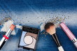 © alekleks - Still life from cosmetics on ragged jeans with rhinestones