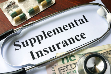 Supplemental Insurance written on a paper.  Medical concept.