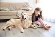 © Africa Studio - Little girl and big kind dog in the living room
