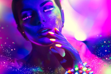 Wall Mural - Fashion woman in neon light, portrait of beauty model with fluorescent makeup