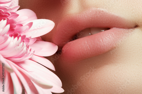 Fotomural Lips with flower. Close-up beautiful female lips with bright lips