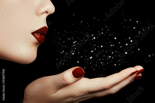 Fotografie, Obraz Beautiful young woman blowing a kiss from her hand