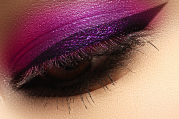 Beautiful macro shot of female eye with creative makeup. Bright make-up