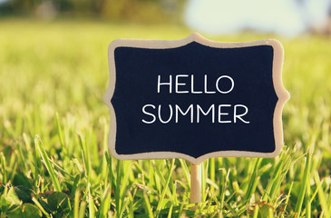 Wall Mural - Wooden chalkboard sign with quote: HELLO SUMMER