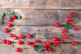 Fototapeta Tulipany - Cherries on a wooden background with copy space 
