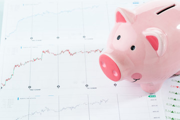  Piggy bank with stock data, investment concept