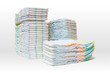 A lot of stacked diapers isolated on white background.