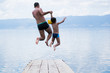 © Nikola Solev - Father and son jumping into lake