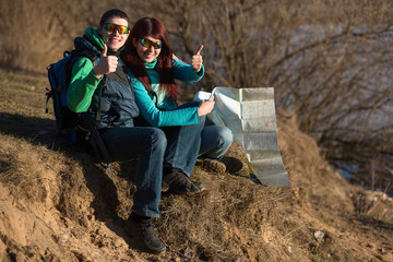 Wall Mural - Young couple hiking with backpacks.