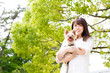 © taka - portrait of young asian woman with dog in the park