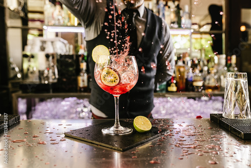 Fotomural Barman is making cocktail at night club.