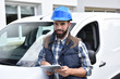 © goodluz - Technician standing by van and using tablet