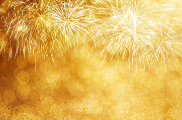 Wall Mural - defocused gold fireworks and bokeh at new year and copy space. abstract background holiday.