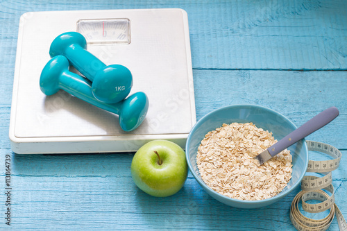 Fotografia Fitness and diet abstract concept with dumbbells