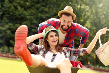 Young couple having fun in the barrow