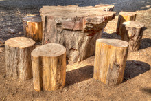 A Table And Chairs In A Picnic Area, Made Out Of Felled Trunks Of Wood, Painterly Effect