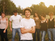 © juripozzi - large group of friends together in a park having fun, back to school