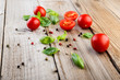 Cherry tomatoes and  basil on wooden table
