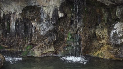 Wall Mural - transparent crystal clear water flowing from cascade. drop falling into a breathtaking lake