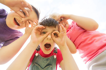 Poster - group of kids having fun and making faces outdoors