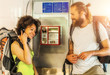 Couple on pay phone laughing