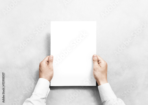 Fotografering Hand holding white blank paper sheet mockup, isolated