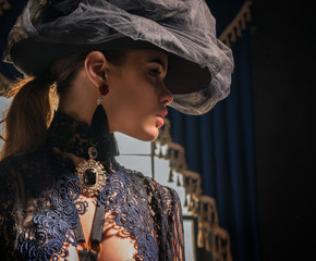 Beautiful face of the girl in a vintage hat and jewel chest