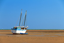 A Beached Sailing Boat At Low Tide On The Beach Of Toliara, Madagascar