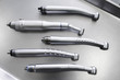 Set of dental turbine handpieces without burs flat lay. Top view on set of dental turbine handpieces on metal medical tray.