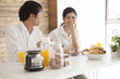 © Monet - Young couple is eating a breakfast happily