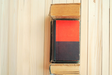 Stack of hardback books on wooden table. Back to school. Copy sp