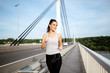 Beautiful woman running on bridge