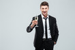 © Drobot Dean - Smiling young businesman with glass of champagne standing and celebrating