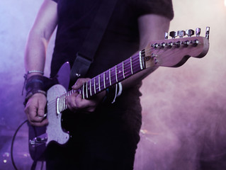 Wall Mural - Silhouette of guitar player on stage.