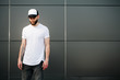 © 4Max - Hipster wearing white blank t-shirt and a baseball cap with spac