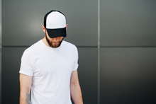 Hipster Wearing White Blank T-shirt And A Cap With Space For You
