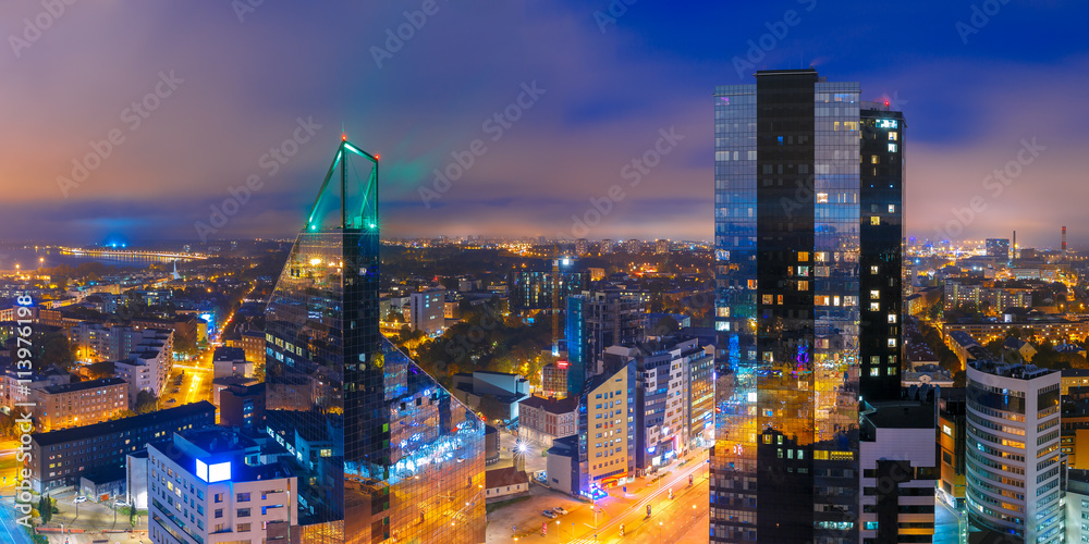 Obraz na płótnie Aerial panorama of modern business financial district with tall skyscraper buildings illuminated at night, Tallinn, Estonia w salonie