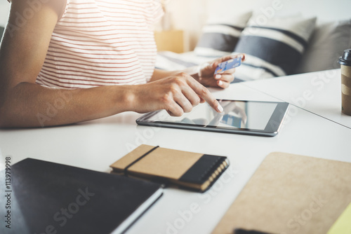 Female Hands Using Modern Digital Tablet And Holding Debit