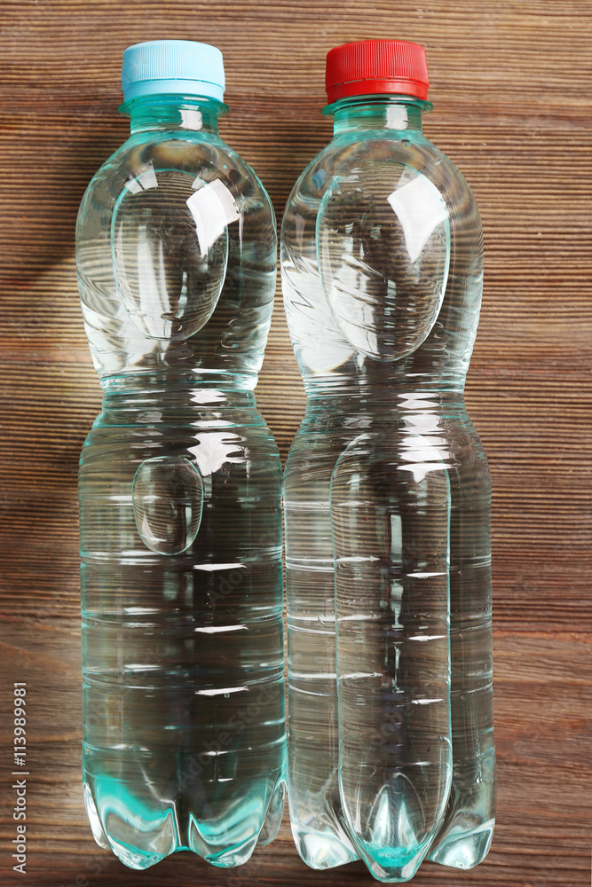 Bottled water on the wooden table, top view