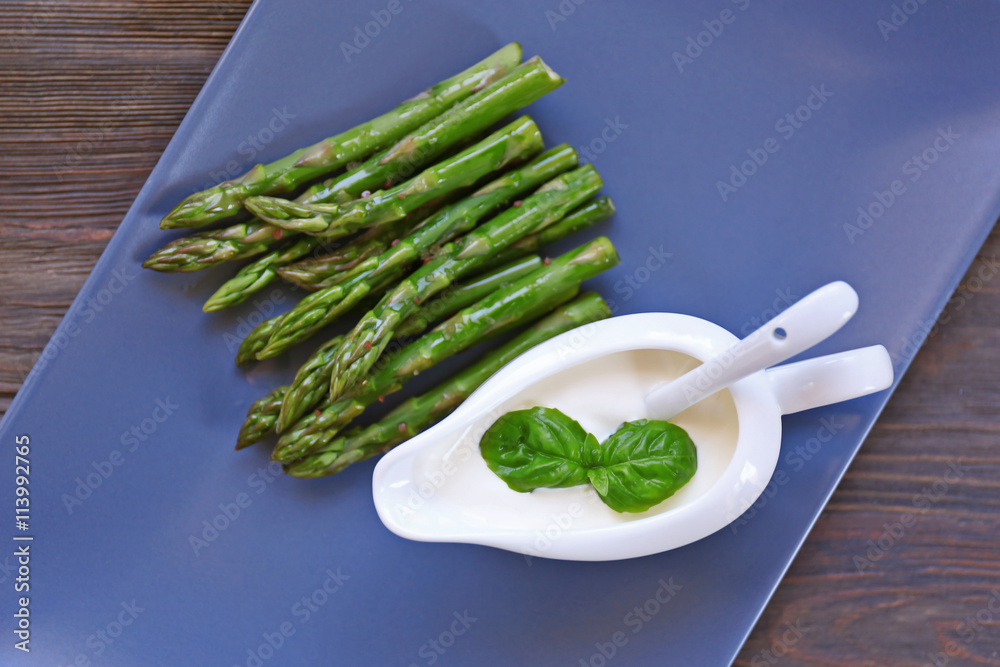Asparagus with sauce on plate