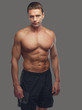 © Fxquadro - Shirtless male isolated on grey background.