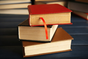 Sticker - Pile of books on wooden background