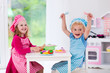 © famveldman - Kids playing with toy kitchen