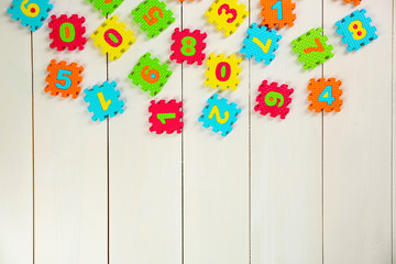 Colorful  puzzle mat on wooden background